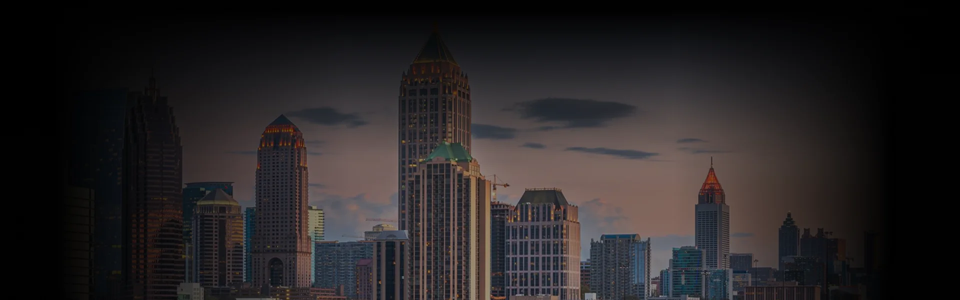 Downtown skyline at dusk showcasing Atlanta's iconic high-rises, ideal backdrop for premium Atlanta Car Service promoting luxury and executive travel.